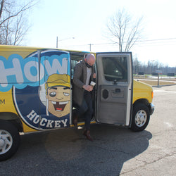 Nicely dressed man stepping out of Howies van