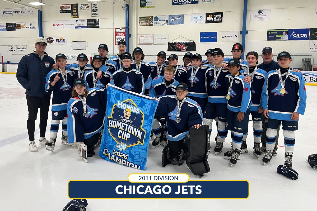 Hockey team posing with a banner on an ice rink, celebrating the 2011 Division Hometown Cup.