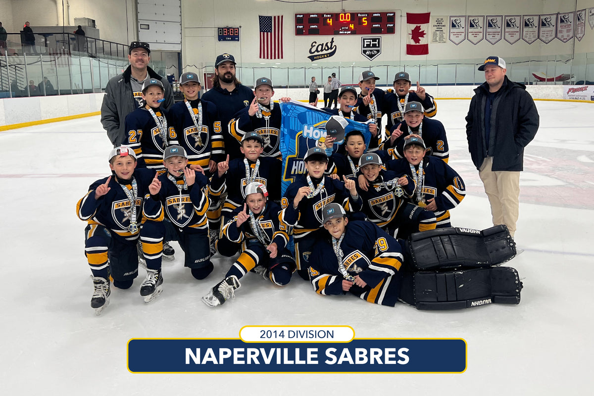 Hockey team posing on an ice rink with a banner and equipment.