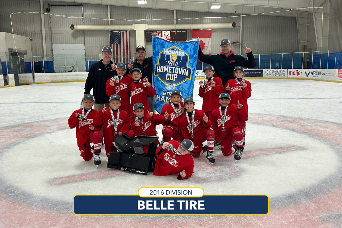 Hockey team celebrating with a trophy on an ice rink, holding a 'Hometown Cup' banner.