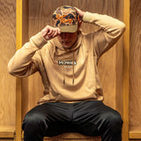 tan hoodie that says Howies in dark letters