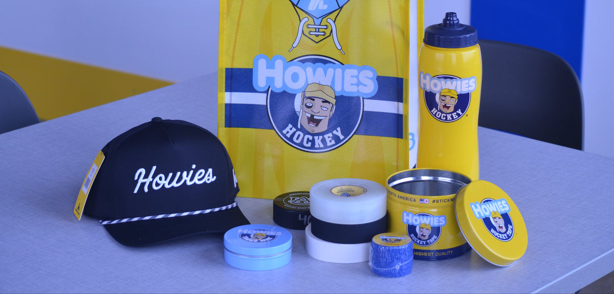 Collection of Howies hockey products including a bag, cap, and various items on a table.