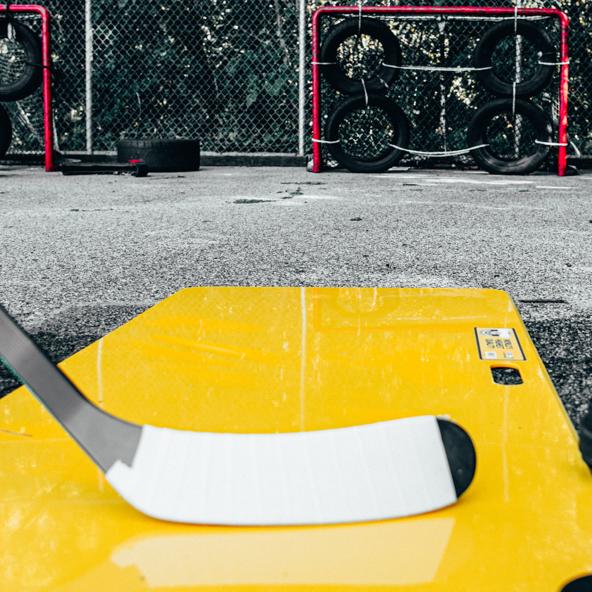 Hockey stick on a yellow howies shooting pad