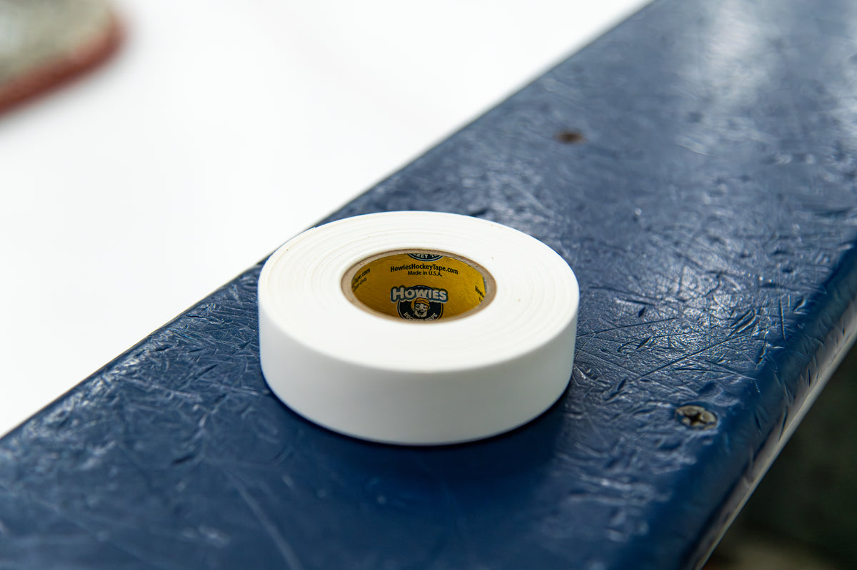 White roll of tape on a blue surface