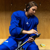 Woman wearing a blue hockey jersey 