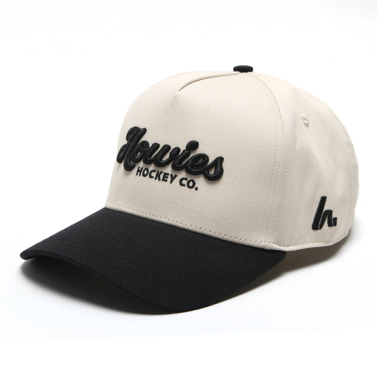 The Clean Sheet Lid by Howies Hockey Co. – cream and black snapback hat with raised black Howies script logo on the front