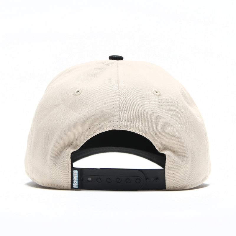 Rear view of the Clean Sheet Lid in cream with a black adjustable snapback closure and Howies tag